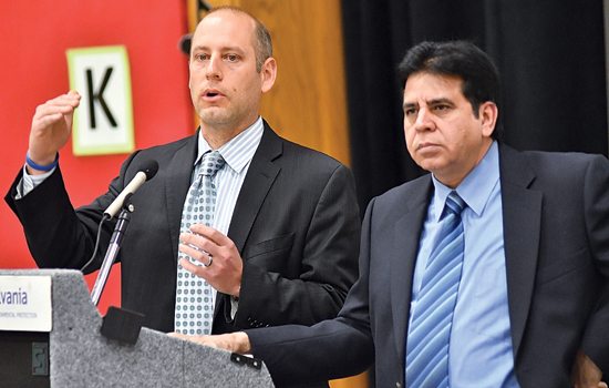 MARK NANCE/Sun-Gazette Marcus Kohl, left, and Muhammad Zaman, both of the PA Department of Environmental Protection answer a question during the DEP's public hearing on Transco Compressor Station 520 at the Salladasburg Elementary School Wednesday.